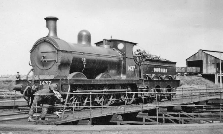 Ex-SER Stirling class O1 at Ashford Locomotive Depot
6th July 1946
Ex-SER Stirling class O1 no.1437 (built October 1897 as Class O, rebuilt March 1914 to O1, withdrawn October 1948) is clearly fresh ex-Ashford Works. Note the man struggling to rotate the turntable.
© Ben Brooksbank (CC-by-SA/2.0)
