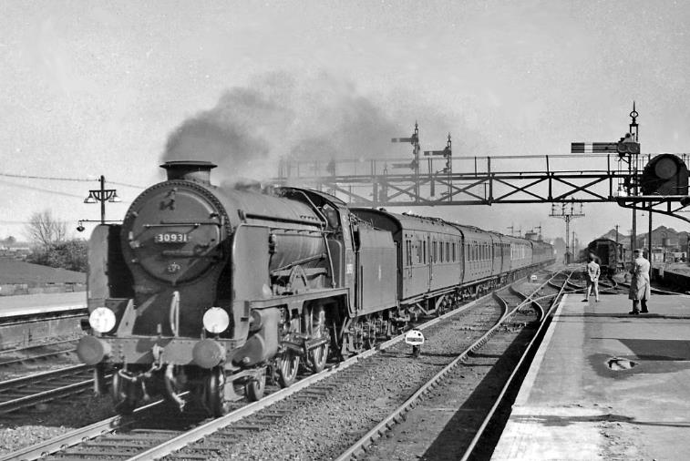 Up express passing Ashford with a 'Schools'
20th April 1957
Heading an Up express, Maunsell Class V 'Schools' no.30931 'King's Wimbledon' was built December 1934, disfigured with a Lemaître blastpipe and double-chimney in Ju;y 1939 and withdrawn September 1961. The line to Rye and Hastings branches off to the right, past the Works.
© Ben Brooksbank (CC-by-SA/2.0)
