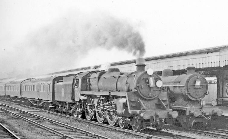 Down Boat express passing through Ashford station.
23rd August 1958
BR Standard Class 5MT no.73042 (built November 1953, withdrawn August 1965) is passing ex-SE&CR L1 class no.31782 on a Down stopping train. (No. 73042 was involved in a serious accident at Eastbourne two days later).
© Ben Brooksbank (CC-by-SA/2.0)

