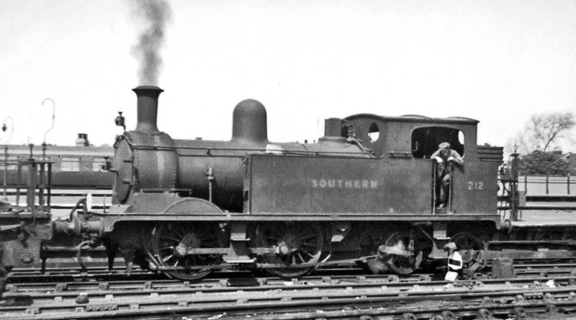 One of the regular Carriage Pilots at Clapham Junction Yard
26th April 1947
Ex-LSWR Adams O2 class no.212 (built May 1892, withdrawn December 1959) is attached to a tool-wagon while it shunts carriages in the vast yards lying between the main and Windsor lines - the London end of the latter being seen behind it.
© Ben Brooksbank (CC-by-SA/2.0)

