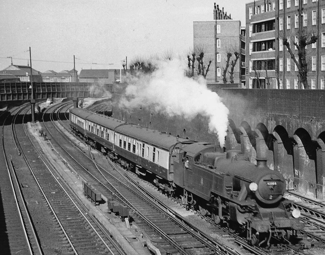 Oxted line train from Victoria leaving Clapham Junction
22nd March 1957
At Falcon Junction about to pass under Strathblaine Terrace bridge, the 2.08pm Victoria - Tunbridge Wells West via Oxted is headed by LMS-type Fairburn 4MT no.42068 (built October 1950, withdrawn December 1963) hauling a Mk1 3-Cor set and van. The ex-LSWR lines from Waterloo are on the right.
© Ben Brooksbank (CC-by-SA/2.0)
