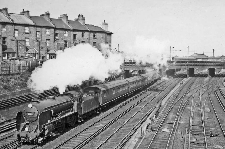 SWD down train pulling away from Clapham Junction with a 'Schools'
2nd April 1958
The locomotive is Maunsell 'Schools' V class no.30903 'Charterhouse' (built April 1930, withdrawn December 1962). On the right is the ex-LBSCR main line from Victoria to East Croydon and Brighton, etc.
The train was noted at the time as 'Empty Stock' but has the headcode for the Salisbury line, so it might be the 11.54am semi-fast from Waterloo running late .
Ben Brooksbank (CC-by-SA/2.0)