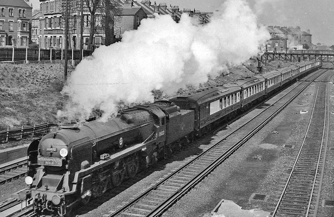 Down 'Bournemouth Belle' west of Clapham Junction
2nd April 1958
About to pass south under Battersea Rise bridge, SR Bulleid 'Merchant Navy' rebuilt no.35022 'Holland-America Line' (built October 1948, rebuilt June 1956, withdrawn May 1966 and now preserved).
© Ben Brooksbank (CC-by-SA/2.0)
