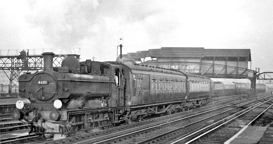 Ex-GWR Pannier tank on empty stock at Clapham Junction
23rd December 1959
'8750' class Pannier tank no.4681 (built November 1944, withdrawn December 1963). Before passing under the great 'A' signalbox with its wartime steel roof, the train will have been drawn through the carriage-washing plant by West London Junction.
© Ben Brooksbank (CC-by-SA/2.0)
