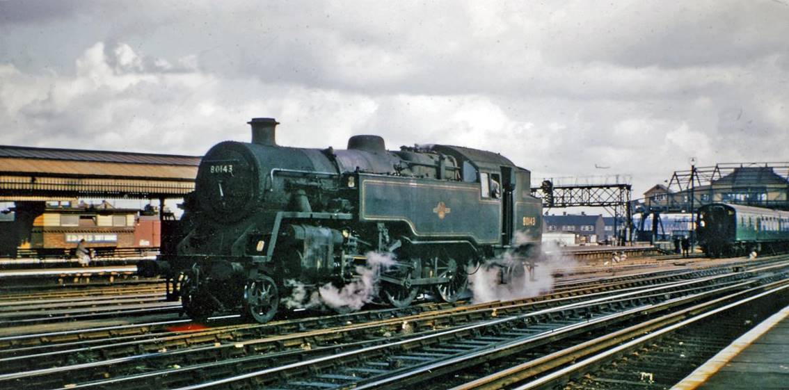 BR Standard 2-6-4T at Clapham Junction
9th September 1965
From the London end of platform 7/8, across to the Windsor Line station, with 'A' signalbox on the right. On the lines into the big Carriage Yard is BR Standard 4MT no.80143 (built September 1956, withdrawn July 1967), engaged in empty stock working during the last years of Steam.
© Ben Brooksbank (CC-by-SA/2.0)
