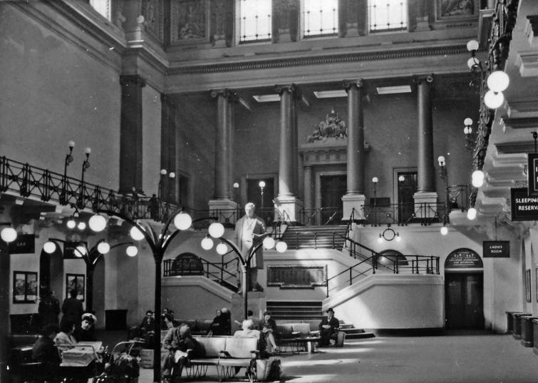 BloodandCustard
Euston Station
Great Hall
10th April 1960
Interior of Great Hall at Euston Station, built by the (then) newly created London & North Western Railway in 1846 at the 1837 terminus of the London & Birmingham Railway. Ahead is the grand staircase leading to the gallery and shareholders' room, past the 1852 statue of George Stephenson.
Removed in 1961 and weighing around six tones, the marble statue of George Stephenson on its plinth was 15' high. It was commissioned from sculptor Edward Hodges Baily (1788-1867). Picked out in gold, its inscription reads:
George Stephenson; Born June 9th 1781; Died August 12th 1848
Being a Sunday there are relatively few people around - except the inevitable sleeping drunk. A splendid place for a booking-office, but you normally bought your ticket from a little guichet outside in a narrow passageway. This was all destroyed in 1962.
Ben Brooksbank (CC-by-SA/2.0)