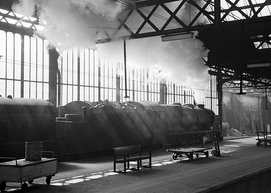 BloodandCustard
Euston Station
April 1960
Sunshine streaming through the glazed curtain wall alleviates the generally dingy atmosphere of the old Euston Station. Royal Scot class no.46153 'The Royal Dragoon' makes its departure.
 Alan Murray-Rust (CC-by-SA/2.0)
