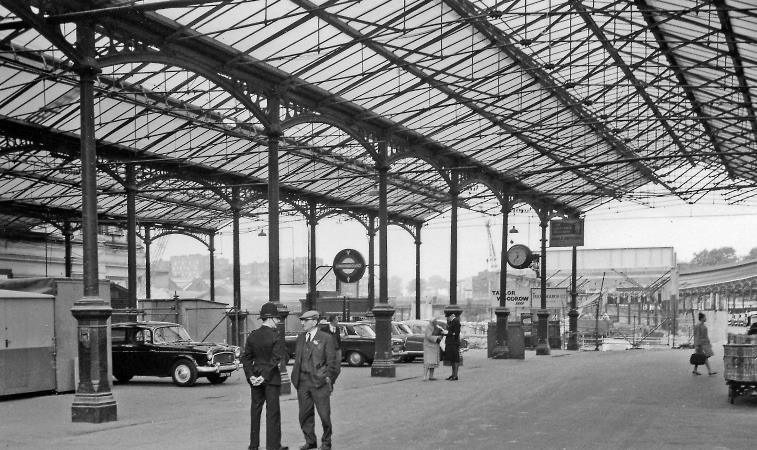 BloodandCustard
Euston Station
Arrival side 
28th August 1963
A transitional view outward on the remains of the roadway between the former Platforms 2 and 3, showing the entrances to the Underground station.
© Ben Brooksbank (CC-by-SA/2.0)
