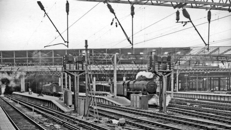 BloodandCustard
Euston Station
Arrival platforms 
17th July 1965
Looking inwards from the end of the Arrival platforms. Main-line electric trains started to run in November 1965 and here the wires are already up, but a steam locomotive (Stanier 5MT no. 45292) is still to be seen. The New Station is now recognisable.
© Ben Brooksbank (CC-by-SA/2.0)
