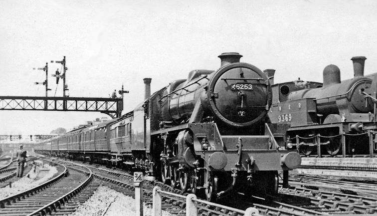 BloodandCustard
Marylebone Station
8.25am from Manchester
16th June 1948
LMS Stanier Class 5 no.45253 was taking part in the extensive Exchange Trials of 1948 just after Nationalisation of the Railways, working the Eastern Region (ex-Great Central) 08.25 express from Manchester via the Woodhead Route and Sheffield (Victoria); a dynamometer car is behind the locomotive for close examination of its performance. On the right is an ex-GC tank engine no.9369 in the Milk Siding. 
 I was not the only photographer: another is on the left and two up on the signal gantry .
  Ben Brooksbank (CC-by-SA/2.0)