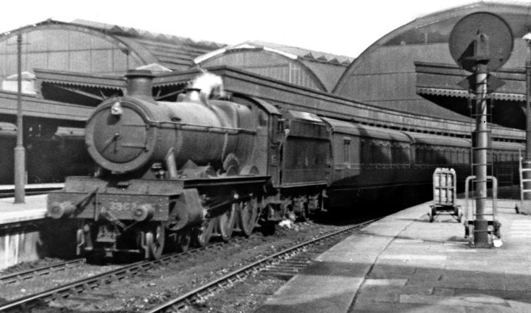 BloodandCustard
Paddington Station
Oil-burning 'Hall' 4-6-0 at Paddington
5th July 1947
From Platform 2/3 a Down stopping train waits to leave Platform 4, with an unusual locomotive: 'Hall' No. 4907 'Broughton Hall', built January 1929, renumbered 3903 as one of eleven 'Hall's temporarily converted (May 1947   April 1950) to oil burning under the Government's abortive scheme during the post-war coal shortage: note the oil-tank in the tender. 
 With apologies for the poor quality of the photograph .
  Ben Brooksbank (CC-by-SA/2.0)