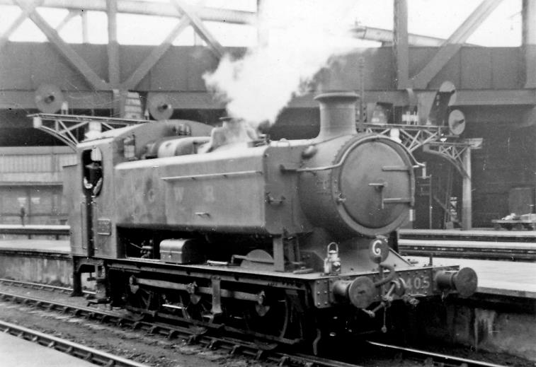 BloodandCustard
Paddington Station
New - and novel - GWR Hawksworth '9400'
5th July 1947
After the War, Hawksworth introduced an enlarged version, the '9400' class, of the traditional 0-6-0 Pannier tank. With Bishops Bridge above, no.9405 was only a month old (built May 1947, withdrawn June 1965) when backing out after the empty train it had brought in had departed.
  Ben Brooksbank (CC-by-SA/2.0)