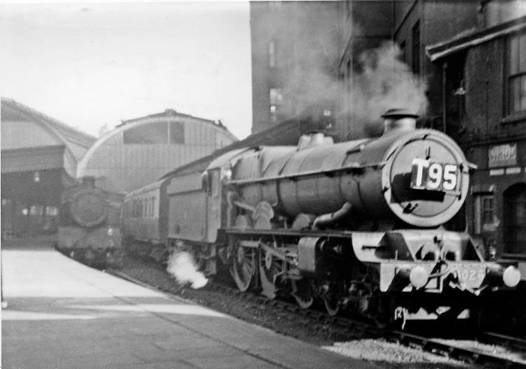 BloodandCustard
Paddington Station
Evening expresses at Paddington
5th July 1947
From Platform 2/3 'King' no.6026 'King John' (built July 1930, withdrawn September 1962) is waiting to leave from Platform 1 on the 6.30pm to Bristol, while at Platform 2 the 6.35pm to Cheltenham has 'Saint' no.2954 'Tockenham Court', a relic from 20 - 30 years earlier - built March 1913, withdrawn July52.
  Ben Brooksbank (CC-by-SA/2.0)