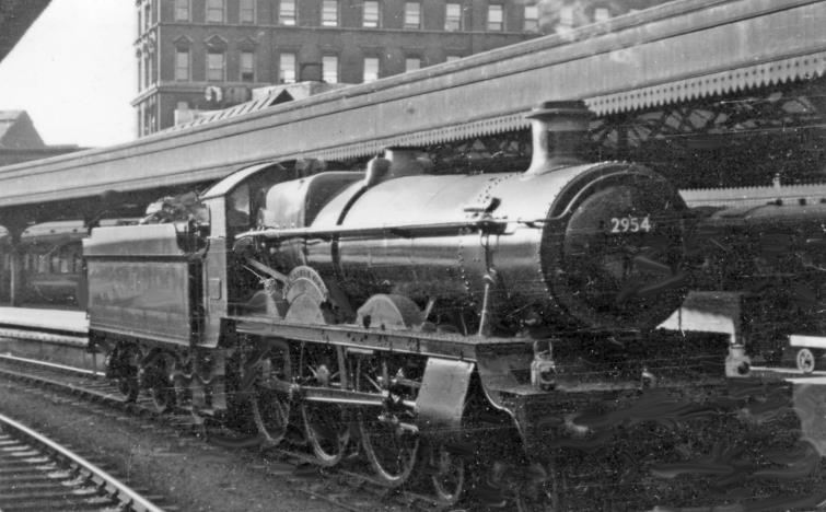 BloodandCustard
Paddington Station
A 'Saint /Court' 4-6-0 at Paddington
13th May 1950
Moving out from Platform 5 is one of the Churchward 'Saint' 4-6-0s that survived into the early 1950s, no. 2954 'Tockenham Court'.
(Built March 1913, withdrawn July 1952).
© Ben Brooksbank (CC-by-SA/2.0)
