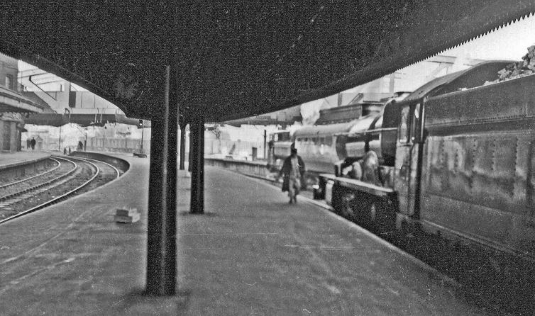 BloodandCustard
Paddington Station
Paddington Station, exit on Departure side
2nd February 1957
Towards Bishops Bridge from near the end of Platforms 2/3, on the right at Platform 3, 'King' no.6004 'King George III' waits to leave on the 'Merchant Venturer', 11.15am to Bristol and Weston-super-Mare.
© Ben Brooksbank (CC-by-SA/2.0)
