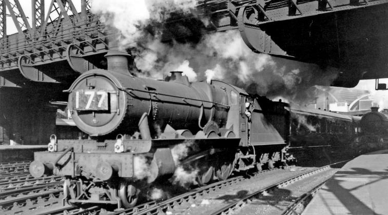 BloodandCustard
Paddington Station
Relief Express to Cheltenham leaving Paddington
23rd May 1958
Seen from the end of Platforms 2/3, 'Hall' no.5987 'Brocket Hall' (built November 1939, withdrawn July 1962) blasts away underneath Bishops Bridge with a Whitsun relief to the 6.35pm to Cheltenham.
 Ben Brooksbank (CC-by-SA/2.0)
