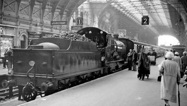 BloodandCustard
Paddington Station
'City of Truro' at Paddington 
23rd July 1958
From the buffer stops on Platform 2 at Paddington.
 The scene is typical of the terminus in those days, normally the locomotive on empty-stock work would have been a 2-6-2T or 0-6-0T. However, on this occasion I was astonished to see the veteran record-breaking no.3440 'City of Truro'. After preservation for 26 years, it was restored to working order by BR in 1957 and based at Didcot put to regular revenue-earning service. For a month in July 1958, this entailed working up to Paddington on a morning residential train and back in the evening, thence put on empty stock work during the day.  
  Ben Brooksbank (CC-by-SA/2.0)