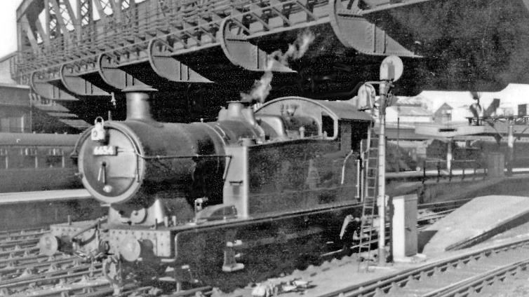 BloodandCustard
Paddington Station
Rare visit of a '5600' 0-6-2T to Paddington
23rd May 1958
Standing at the end of Platform 5 under the Bishop's Road Bridge, probably after working empty stock from Old Oak Common, Collett '5600' class 0-6-2T No. 6654 (built August 1928, withdrawn June 1965) is the rare visitor. Most of the Class worked in South Wales, a few elsewhere, but only the odd one was brought to the London Division (in the mid-fifties), none to 81A (Old Oak Common).
  Ben Brooksbank (CC-by-SA/2.0)