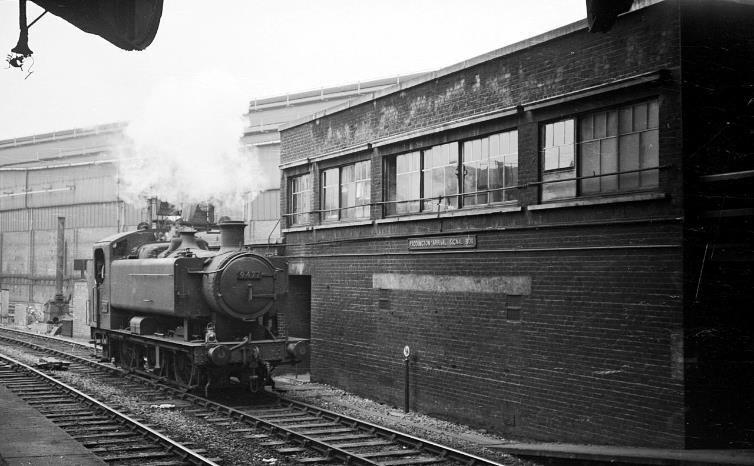 BloodandCustard
Paddington Station
Paddington Arrival Signal Box 
April 1961
Late design of signal box by the Great Western Railway associated with the installation of colour light signalling at larger stations. Opened in 1939 as a rebuild after a fire in 1938 of the original 1933 box.
The locomotive was 9477, one of a class of heavier 0-6-0 pannier tanks introduced shortly before nationalisation for heavy shunting duties. A number were allocated to the London area for empty stock working into and out of Paddington.
 Note also the milepost showing that although the photographer is still on the platform, he is a quarter of a mile from the buffer stops! 
  Alan Murray-Rust (CC-by-SA/2.0)