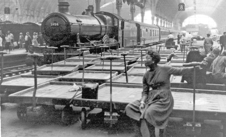 BloodandCustard
Paddington Station
Scene from barrier on Arrival side (Platform 8) at Paddington Station
1st July 1961
Collett no.5994 'Roydon Hall' (built December 1939, withdrawn March 1963) at Platform 8; another express has just arrived at Platform 6. The collection of barrows was no doubt awaiting the Mail traffic that night. 
 The girl accidentally featured was a total stranger! 
  Ben Brooksbank (CC-by-SA/2.0)