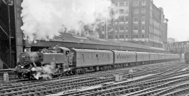 BloodandCustard
Paddington Station
Empty stock train entering Paddington
3rd August 1963
From the end of the long Platform 8/9, with the long Parcels Platform extending from No. 1 behind. Headed by the first of the new small group of outside-cylinder Pannier Tanks introduced by Hawksworth in 1949, no.1500 (built June 1949, withdrawn December 1963) having passed under Westbourne Bridge, the train has come from Old Oak Common Yard over the flyover at Ladbroke Grove.
© Ben Brooksbank (CC-by-SA/2.0)
