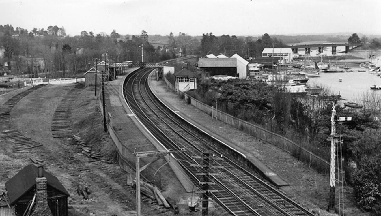 Bursledon 
View towards Fareham and Portsmouth (electrified since 1990). At top right can be seen the bridge carrying this line across the River Itchen (19th April 1963).
 Ben Brooksbank (CC-by-SA/2.0)
