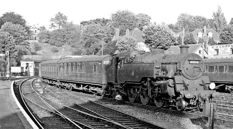 Tunbridge Wells West
View towards Tunbridge Wells Central on 18th June 1961.
The train is the 7.10pm Tonbridge to Brighton, headed by BR Standard 4MT no.80150 (built at Brighton 28th December 1956 and withdrawn 17th October 1965 - now preserved). Maunsell coaching set 217 was formed 10th March 1931 it was outshopped from CLC-livery into Green 5th December 1957 thence disbanded 16th May 1964.
Ben Brooksbank (Geograph/CC-by-SA)