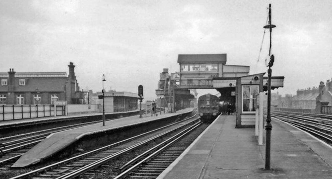 Battersea Park
View towards Clapham Junction on 2nd March 1961.
The South London line platforms curve away to the left whilst Battersea Park’s impressive signal box sits above the slow lines and a 4 SUB unit en-route to Victoria.
© Ben Brooksbank (Geograph/CC-by-SA)
