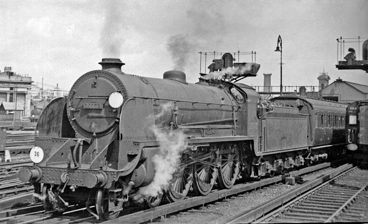 Bournemouth express at Waterloo
24th June 1950
Seen from the end of Platform 13 (where the rear end of 4 COR unit no.3104 on a electric Portsmouth express is visible), the 10.54am Summer Saturday express to Bournemouth West is ready to leave with a Maunsell N15 Class no.30773 'Sir Lavaine' (built June 1925, withdrawn February 1962).
© Ben Brooksbank (CC-by-SA/2.0)
