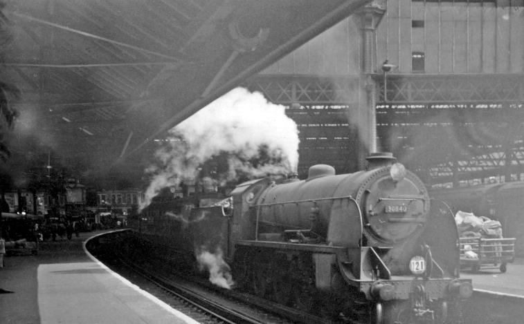 Maunsell S15 class in the depths of Waterloo
5th August 1964
From Platform 13, the 11.54am semi-fast to Basingstoke is soon to leave Platform 12 headed by relatively young S15 no.30840 (built June 1936, withdrawn September 1964 - very soon after this photograph).
British Rail introduced the 24-hour clock (nationally) for public and working timetables from 14th June 1965.
 Ben Brooksbank (CC-by-SA/2.0)
