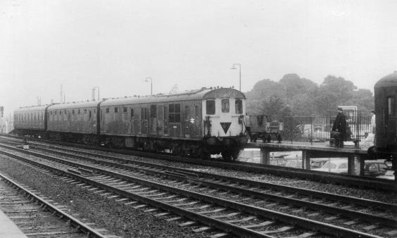 In the days before Readings platform 4B, unit no.1201 is called-into platform 4A behind a pair of 2 HAL units on a wet & dismal Saturday in June 1969. 
The units next driver waits on the platform in un-eager anticipation (the DEMUs were in the top-link at Reading depot) while a Post Office worker makes his way along the platform towards the DTS hauling a trolley.
Of particular interest is the previous Winters partial-sheeting over of the lower section of radiator grill (adjacent to the guards brake compartment) has not been removed. 
In a filthy state, the carriage-cleaning staffs brushes could not reach above the observation lights!
 John Atkinson
