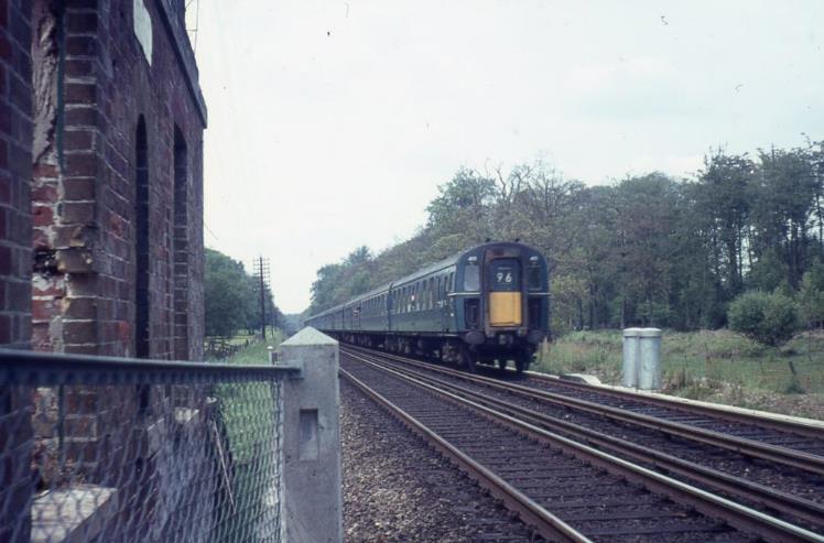 4 TC units nos.411 and 416 propelled by a locomotive (possibly E6009) approaches Lyndhurst Road on a service from Waterloo on Saturday 3rd June 1967, some five-weeks before the launch of the new electric timetable. Headcode 96 (Waterloo to Southampton Terminus) was used quite a lot for driver training trips and unusual west of Tunnel Junction. Not much of a polish on the conductor rail yet either!
 John Hayward
