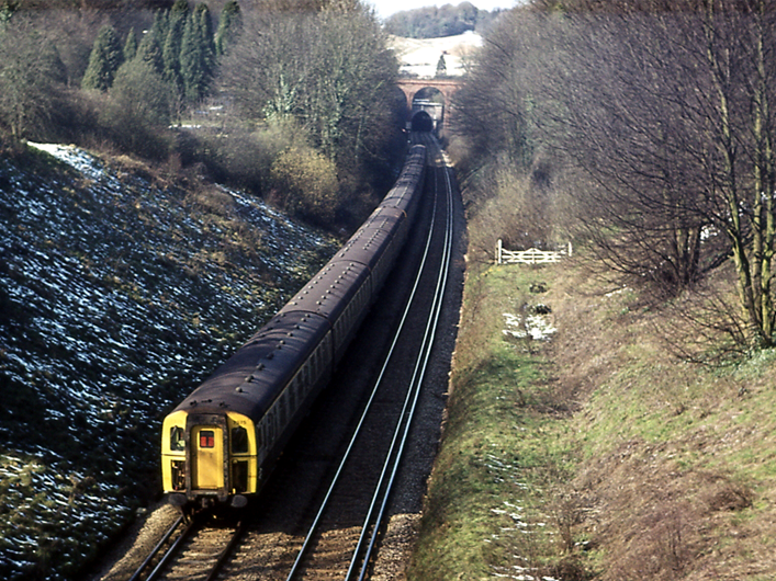 https://www.bloodandcustard.com/BR-4CIG.html

Photographed from Rockshaw Road, this formation on the Up Slow is about to pass under Jolliffe Road bridge prior to entering Merstham Tunnel on Good Friday, 28th March 1975.
To the right is the former branch into Greystone Lime Works (with the course of the Pilgrim’s Way passing just beyond the gates - approximately where the middle of the train is). The branch to the Lime Works crossed the Quarry Line on a bridge immediately in front of Quarry Tunnel’s southern portal.
© Tony Watson

