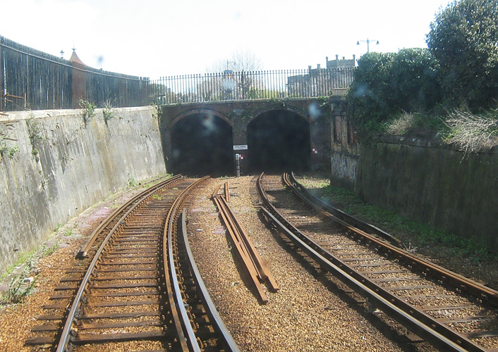 www.BloodandCustard.com
Ryde tunnel’s northern-end portal and curved twin-tunnel section supporting Esplanade, Dover Street and East Street.
Part of the original trackbed inside this twin-tunnel section was below the High Water Mark and suffered regular flooding. With electrification, this flooding necessitated a section of track to be slightly raised; the reduced clearance leading to the use of former LT tube stock 
© C. Watts (23rd April 2008)
