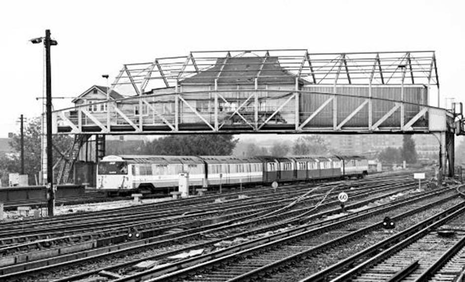 www.BloodandCustard.com Isle of Wight standard stock.

The five-car ‘heritage’ train formed (L-R) of 7, 49, 27, 44 & 2 passing underneath Clapham Junction’s former ‘A’ on  Thursday 18th October 1990 whilst working the 10.29hrs Fratton to Wimbledon Park Depot.
© Chris Wilson
