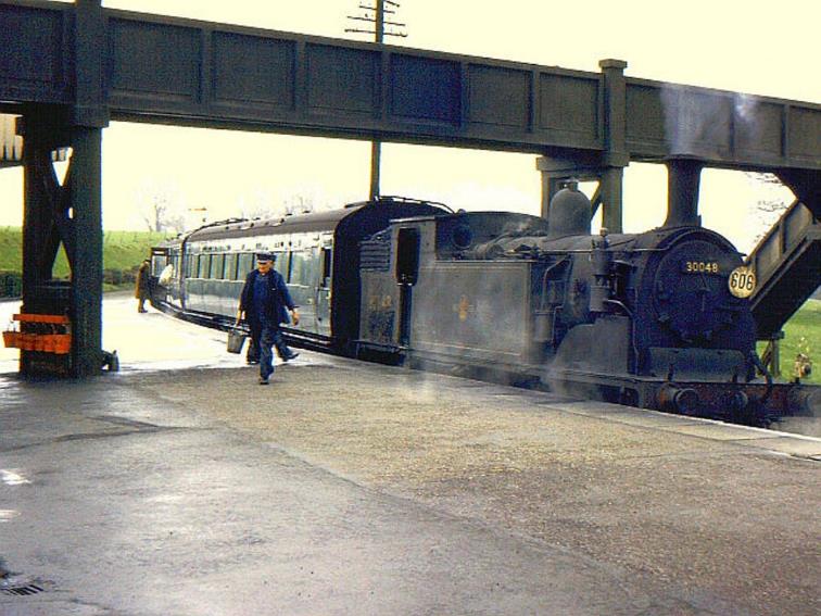 Southern Region
Pull-Push Sets
(Maunsell rebuilds 600-619)
At Seaton Junction M7 no.30048 with an unidentified Maunsell push-pull set is readied for its return to Seaton on a damp Saturday, 20th April 1963.
Note both tail lamp & headcode disc; the latter sporting the drivers duty number.
A row of red fire buckets can be seen hanging off the public footbridge support.
 Richard Green (CC-by-SA/2.0)
