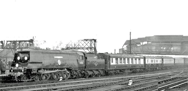 Sir Winston Churchill's Funeral Train
Clapham Junction 
30th January 1965
On the Windsor Lines at Clapham Junction, the train ran from Waterloo to Hanborough via Reading South and Oxford, hauled by SR Bulleid Light Pacific no.34051 'Winston Churchill'. The unique liveried hearse vehicle of the seven-coach Pullman train conveyed the coffin - Sir Winston having died on 24th January 1965 then lain in state. 
The train carried a unique disc headcode representing 'V for Victory'.
This locomotive was built in December 1946 as no.21C151, after withdrawal in September 1965 was saved and preserved in the National Collection at York.
“Mid-winter weather precluded my obtaining a good photograph”.
© Ben Brooksbank (CC-by-SA/2.0)
