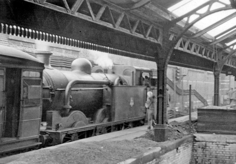 Blackfriars
RCTS Railtour
10th October 1953
At this stage hauled by ex-GN N1 no. 69441, The Railway Correspondence & Travel Society (London Area) Rail Tour has stopped briefly at the remains of Ludgate Hill station on its complex route from Marylebone through Wembley Stadium, Acton Wells, Greenford, Battersea Yard, Loughborough Jcn, Ludgate Hill, Kings Cross, South Tottenham, East Ham, Dalston East Jcn and Broad Street., which included Battersea - Kentish Town via Blackfriars Bridge and the Snow Hill Tunnel, with.
The train will travel north through Holborn Viaduct Low-Level, Snow Hill Tunnel and Farringdon and the Metropolitan 'Widenend Lines'. 
The station had been closed since March 1929 and at the time of the Rail Tour only cross-London freight trains and SR local trains to Holborn Viaduct passed through here. The island platform of Ludgate Hill station was removed in 1974.. 
 Ben Brooksbank (CC-by-SA/2.0)
