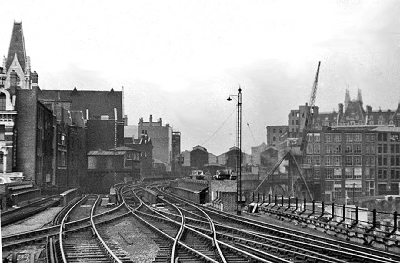 Blackfriars
RCTS Railtour
10th October 1953
The Railway Correspondence & Travel Society (London Area) Rail Tour will tave the far-left track travelling north through Holborn Viaduct Low-Level, Snow Hill Tunnel and Farringdon and the Metropolitan 'Widenend Lines'. 
The tracks on the right lead to Holborn Viaduct (SR) terminus, visible in middle distance. Those on the left are the Metropolitan Widened Lines, plunging down into Snow Hill Tunnel, through Holborn Viaduct Low Level Station which closed in June 1916 (when through passenger services ceased). Freight traffic ceased in March 1969.
The rebuilding of the war-damaged City of London has only just begun.
© Ben Brooksbank (CC-by-SA/2.0)
