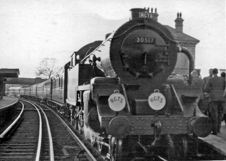 Chertsey
R.C.T.S. (London Branch)
Swindon & Highworth Railtour
This memorable Railway Correspondence & Travel Society Tour on 25th April 1954 had started from Victoria behind two 'Dukedog' locomotives (nos.9023 & 9011) to proceed via Longhedge and Kensington to the WR main line at Old Oak Common. 
At Swindon the Works was visited and a Special continued to Highworth and back. 
On the return journey a 47XX class no.4707 brought the tour back to Reading General, where (ex-LSW) Urie class H16 no.30517 (built November 1921, withdrawn December 1962) took over and deviating short of Virginia Water onto the - normally freight-only - loop to the line to Weybridge. 
From there it was up the main line to Wimbledon, thence the East Putney loop to pass through Clapham Junction on the Windsor Lines before finally reaching Victoria via Longhedge Junction. 
From Clapham Junction C class no.31480 hauled the train for the last leg into Victoria.
Coaching stock was Loose - S4433S (Nondescript Brake Open) + S1436S (Third Class Open) + S1386S (Third Class Open) + S7954S (Cafeteria Car) + S1399S (Third Class Open) + S1307S (Third Class Open) + S4441S (Nondescript Brake Open).
