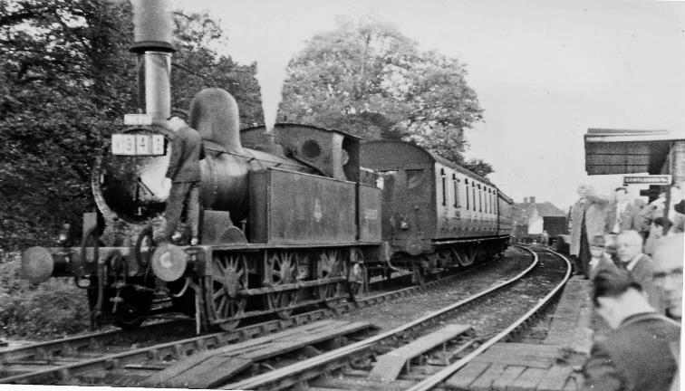 Newport Pagnell
RCTS Buckinghamshire Rail Tour
View westward, towards Wolverton. Ex-LNWR Webb 'Coal Tank' 2F no. 58887 (designed 1882, withdrawn April 1955) has run round its train from Wolverton. This is part of the RCTS 'Buckinghamshire Rail Tour' - and the fireman is changing the headlamps for the return run. This engine also took the train from Cheddington to Aylesbury High Street and back on the complex tour that had started /ended at Blackfriars behind T9 no30729 as the Inter-Regional Ramblers Special. 
The Newport Pagnell branch from Wolverton was closed to passengers on 7th September 1964 and to goods on 22nd May 1967.
 Ben Brooksbank (CC-by-SA/2.0)
