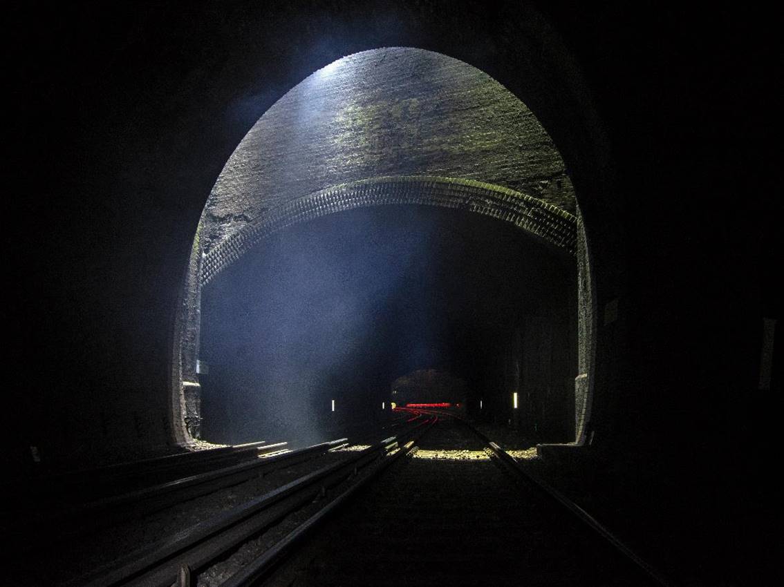 www.BloodandCustard.com

Redhill tunnel sits on the Quarry Line and passes under Red Hill. Sunlight streams down through the slit-vent between the brick-lined (dug) tunnel and the lower cut-and-cover section carrying the ex.SER mainline from Redhill to Tonbridge.
 Adrian Backshall (13th July 2019)
