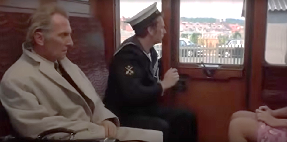 A person in a uniform sitting in a train

Description automatically generated