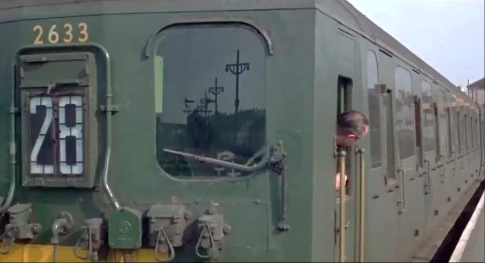 A train with a person in the window

Description automatically generated