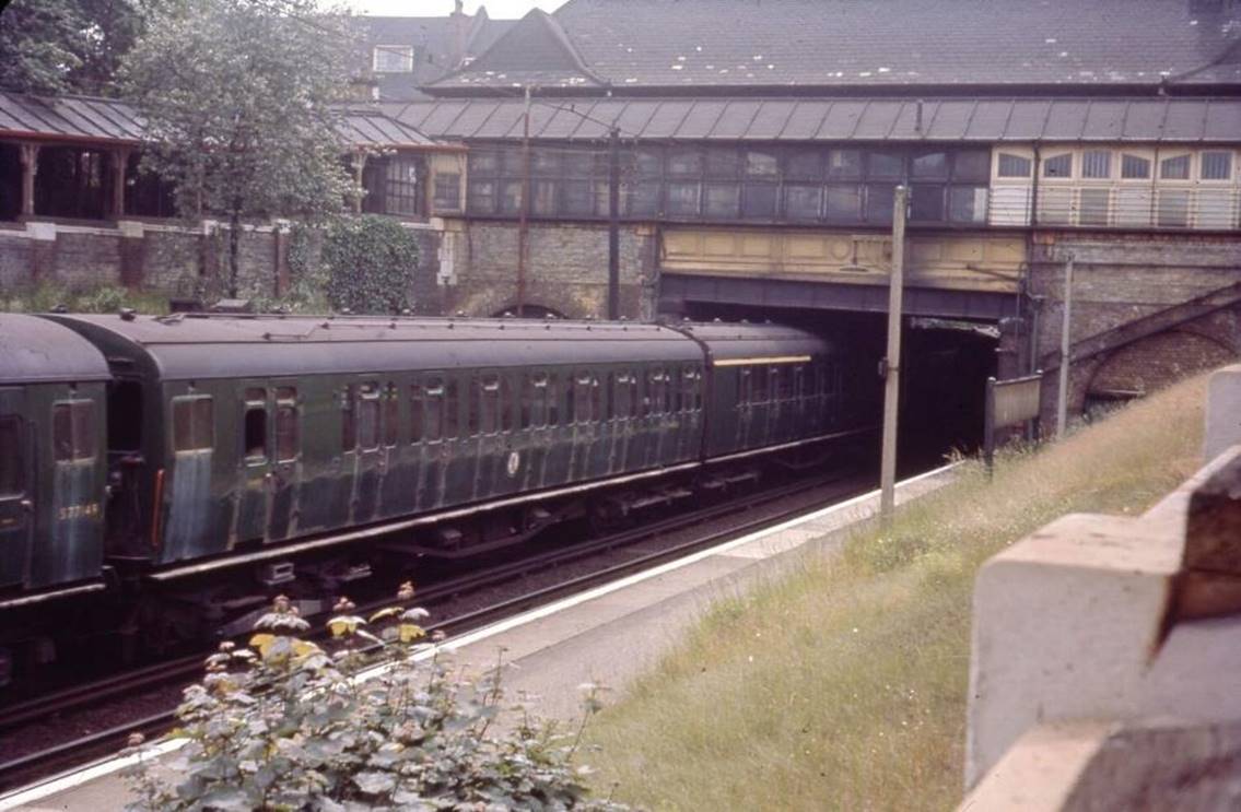 On an Up service unidentified 2 HAP (SR-design) leads 2 HAP no.6053 (BR-design) leaving Eltham Park station. Still with whistles but sporting UIC yellow cantrail band, both green-liveried units look particularly worse for wear with acid-stains 
after a visit to the carriage-washer. Although Eltham Park station closed on 17th March 1985 the station building remains. 
 BloodandCustard
