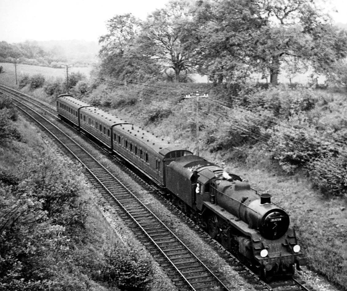 From White Down Lane overbridge, an unidentified Birdcage trio approaches Gomshall & Shere on the 5.31pm Redhill to Reading South train (1st June 1957) hauled by BR Standard 4MT no. 76054.
 Ben Brooksbank (Geograph/CC-by-SA)
