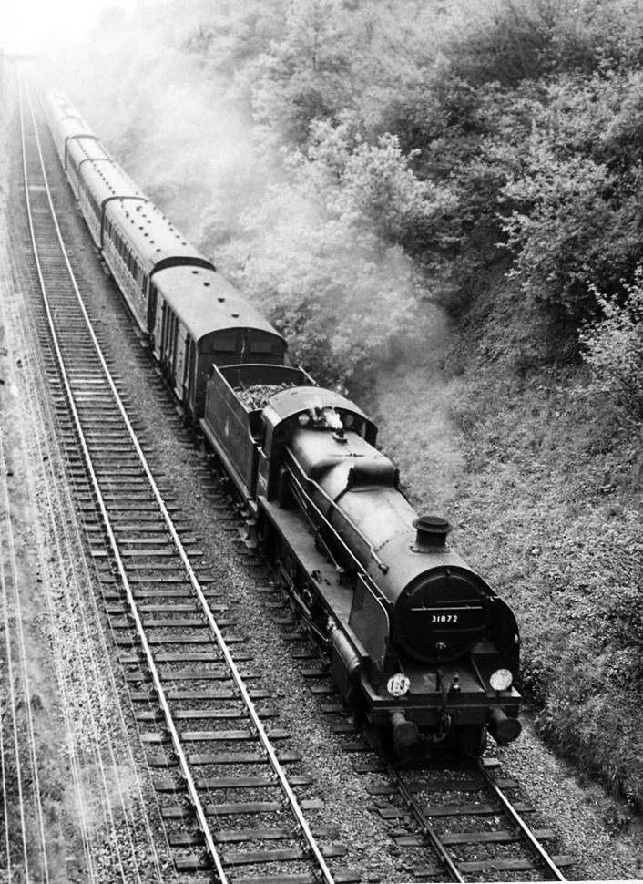 From White Down Lane overbridge, a six-coach train (plus van) contains an unidentified Birdcage trio east from Gomshall & Shere on the 4.20pm Reading South to Redhill train (1st June 1957) hauled by N class no. 31872. 
 Ben Brooksbank (Geograph/CC-by-SA)
