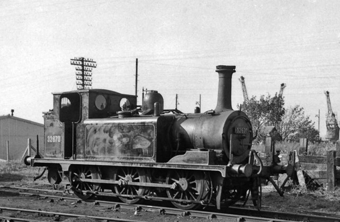 No.32670 at Newhaven Locomotive Depot on Sunday, 7th October 1962.
Fitted with a spark-arrestor for work in the Docks, No. 32670 the last of the celebrated 'Terriers', had a long history. Built by Stroudley as A1 class no. 70 'Bodiam' in December 1872, it was sold to the Kent & East Sussex Railway in 1901 to become their no.3. 
Withdrawn in 1931 it returned to service on the SR in 1933, rebuilt to A1X in 1943, withdrawn by BR in November 1963 as 32670 only to be acquired by the new Kent & East Sussex Railway as no. 3 'Bodiam'.
 Ben Brooksbank (Geograph/CC-by-SA)
