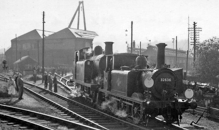 Newhaven Locomotive Depot Sunday, 7th October 1962.
“Enthusiasts off the RCTS Sussex Rail Tour mill round the Locomotive Yard and watch the two ex-LBSCR engines which worked our Special from Lewes to Seaford and back to Brighton”.
No. 32636, a Marsh A1X rebuild (1913) of Stroudley A1 class Terrier no.72 'Fenchurch' of September 1872, which belonged to the Newhaven Harbour Co. 1898-1926, thence SR no.B636, 2636 and BR no.32636. Withdrawn in November 1963 it is preserved by the Bluebell Railway as no. 72 'Fenchurch'.
Behind is R. Billinton E6 class no.32418, built December 1905, withdrawn December 1962. 
© Ben Brooksbank (Geograph/CC-by-SA)

