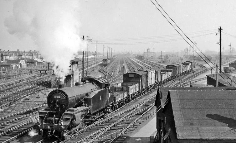 www.BloodandCustard.com
Feltham Marshalling Yard looking east along the 'Windsor Lines towards Clapham Junction. One of the largest marshalling yards in the country, Feltham was purpose-built by the LSWR in 1921-22 to handle almost all the freight traffic to and through London on the Southern Railway Western Section - about 5,500 wagons per day. 
On 1st April 1958 locomotive no.30493 (built July 1921, withdrawn December 1959), was one of the Urie G16 class of four 4-8-0Ts specially built for shunting over the humps of the Feltham Up and Down Yards: it is working the Down Yard and passing Feltham East Box, the main line being on the left and the Up Reception lines next to it. All this was completely swept away by January 1969 and is now a Nature Reserve.
 Ben Brooksbank (CC-by-SA/2.0)
